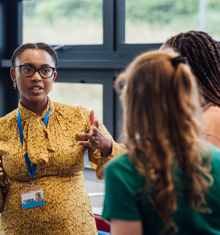 Woman speaking to two other people